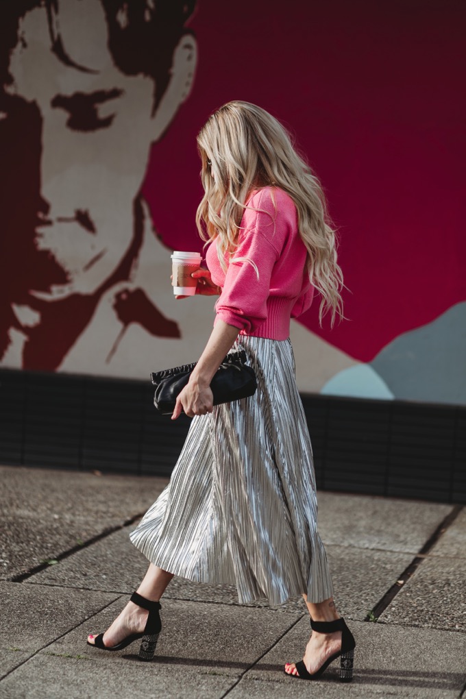 Erika Altes from Whiskey and Lace blog wearing a pleated metallic skirt with pink cropped sweater